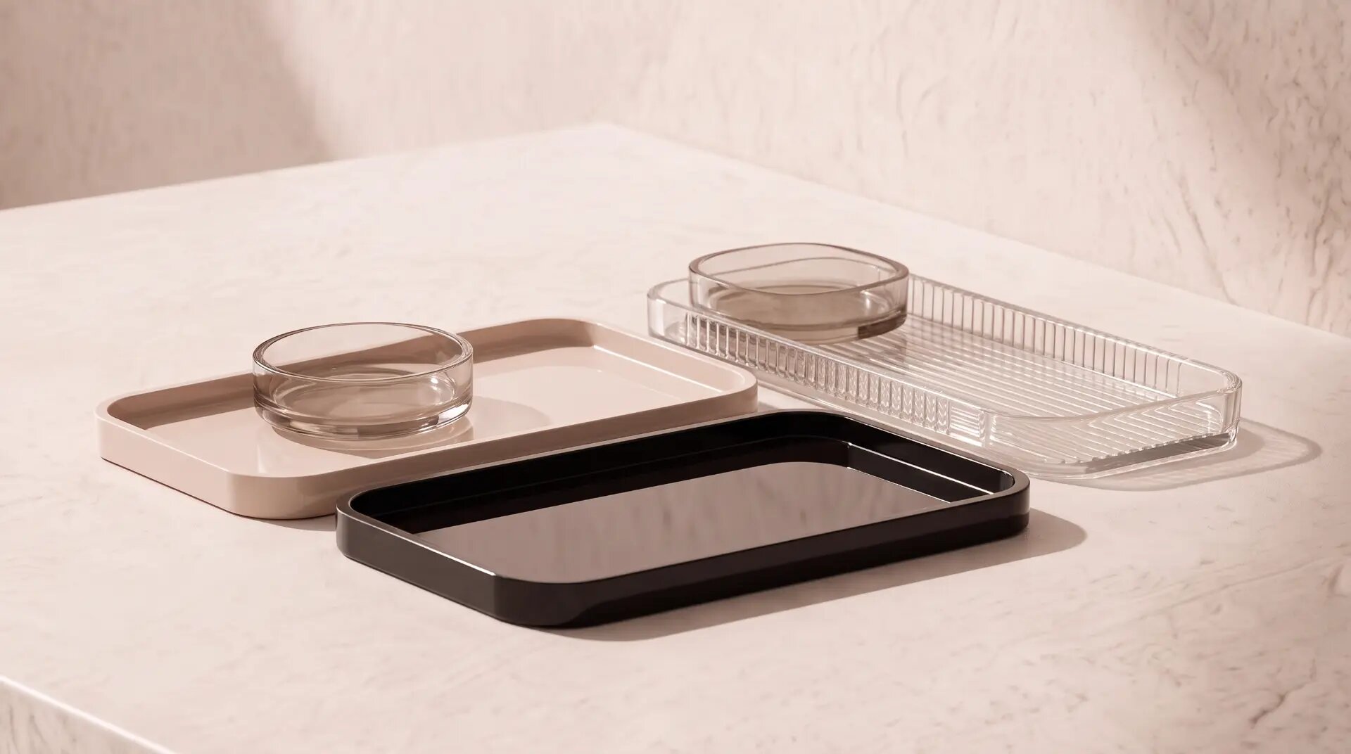 Ledge, blush, black and fluted clear trays on stone