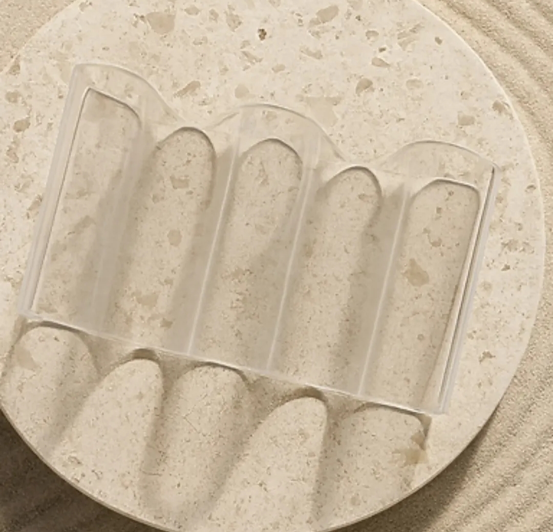 Clear cast acrylic Wave holder resting on a limestone disc
